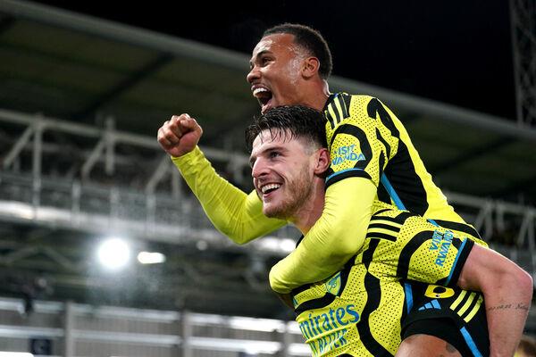 ELATION: Arsenal's Declan Rice (bottom) and Gabriel celebrate victory. Pic: Joe Giddens/PA Wire