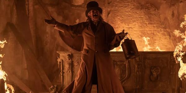 Willem Dafoe as Prof. Albin Eberhart Von Franz laughing while surrounded by fire