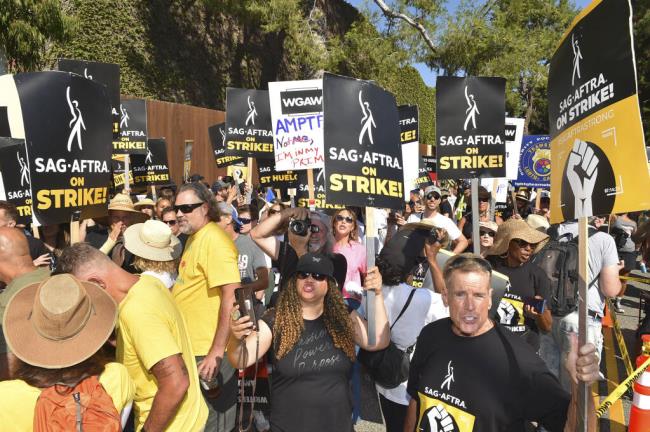 Protesters attend the Day of Solidarity union rally on Tuesday, Aug. 22, 2023, at Disney Studios in Burbank, Calif. The event includes members of SAG-AFTRA, the WGA and the AFL-CIO. (Photo by Jordan Strauss/Invision/AP)