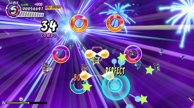 Two sets of paired rhythm balls move from center-screen to the outer targets in Samba de Amigo: Party Central.
