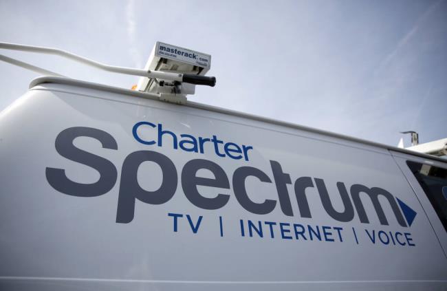 A Charter Communications van is shown Wednesday, April 1, 2015, in Town and Country, Mo. (AP Photo/Jeff Roberson)