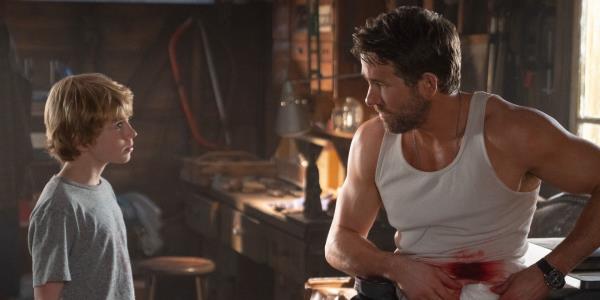 Walker Scobell and Ryan Reynolds bleeding from his abdomen in The Adam Project
