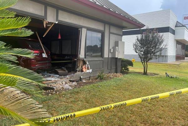 Police tape in front of the Denny's restaurant after a vehicle crashed into it in Rosenberg, Texas.
