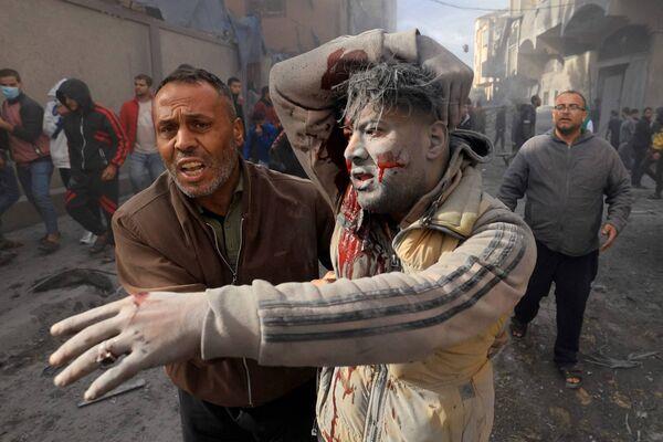 TOPSHOT - An injured Palestinian man gestures after in an Israeli strike on Rafah in the southern Gaza Strip on November 20, 2023. Picture: MAHMUD HAMS/AFP via Getty Images)