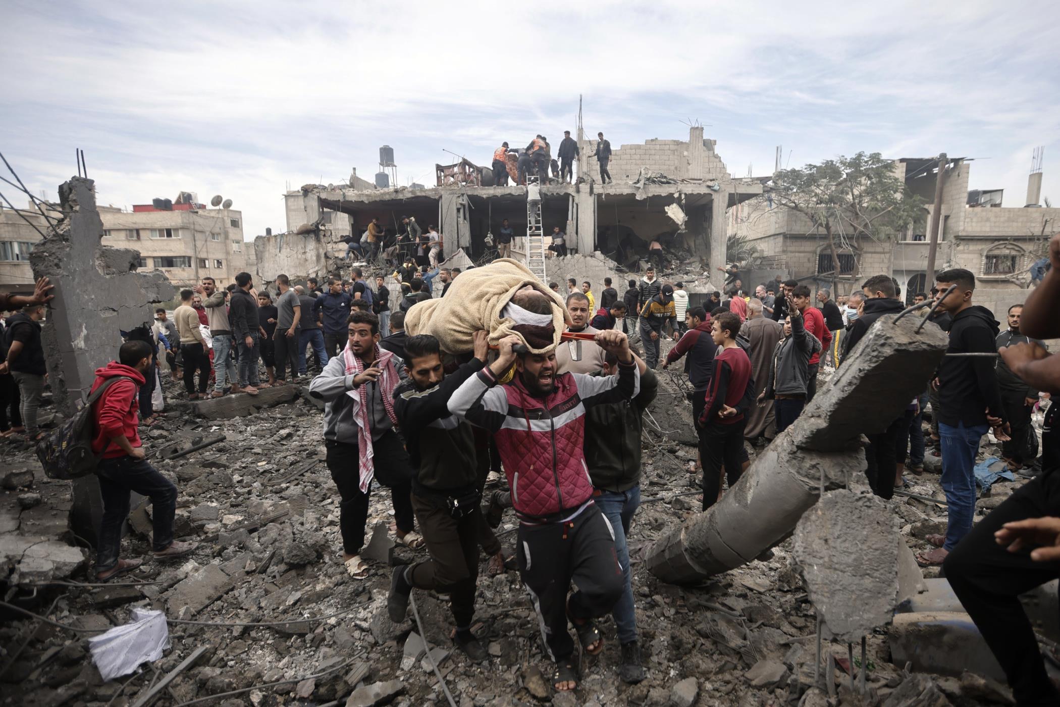 Palestinians evacuate a wounded woman following Israeli airstrikes in Khan Younis refugee camp, Gaza Strip, Palestine Dec. 7, 2023. (AP Photo)